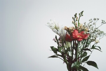 Fototapeta premium A vase filled with flowers sits on a table
