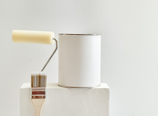 Geometric podium or pedestal with paint can, brush, sponge roller on a white background. Mock up...