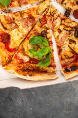 pizza chicken meat and olives, sausages, cheese, tomato sauce fresh meal food snack on the table copy space food background rustic top view