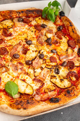 pizza chicken meat and olives, sausages, cheese, tomato sauce fresh meal food snack on the table copy space food background rustic top view