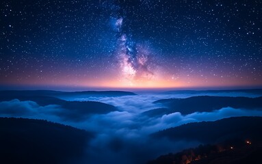 Obraz premium A breathtaking view of the Milky Way over misty hills at dawn.