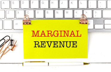 MARGINAL REVENUE text on yellow sticky on keyboard