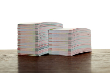 Stacks of business cards on wooden table against white background