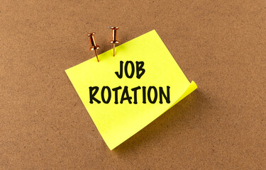 JOB ROTATION text on yellow sticky on board background