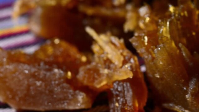 Close-up video of traditional Salvadoran Chilacayote candy, a sweet, caramelized dessert enjoyed during festive August fairs.