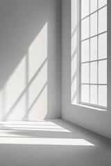 Obraz premium Minimalist white room with sunlight through window casting shado
