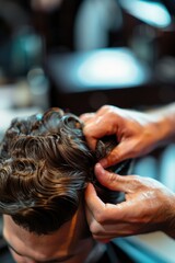 A man sitting in a barber chair having his haircut, a classic scene of grooming and personal care