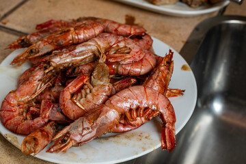 Delicious dish of grilled prawns separated from a large paella