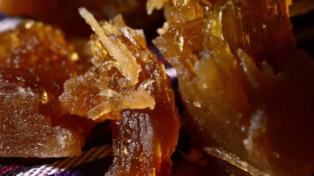 Close-up video of traditional Salvadoran Chilacayote candy, a sweet, caramelized dessert enjoyed during festive August fairs.