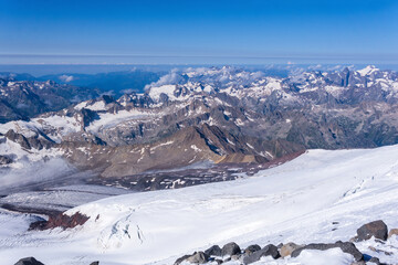Fototapeta premium top view of the high mountains above the clouds from the glacier on the slope of Mount Elbrus