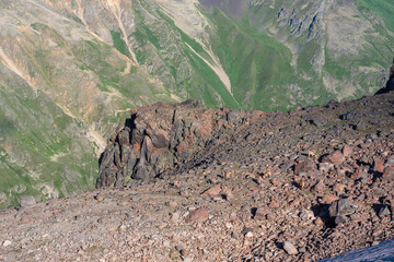 high mountainous landscape with a herd of caucasian ibex in the foreground
