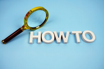 How to word with magnifying glass top view on blue background
