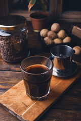 Glass of coffee brewed in traditional vietnamese coffee phin