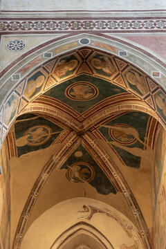 Florence, Italy - Aug 19, 2021: Vaulted ceiling frescoes of the Peruzzi Chapel in Santa Croce Basilica