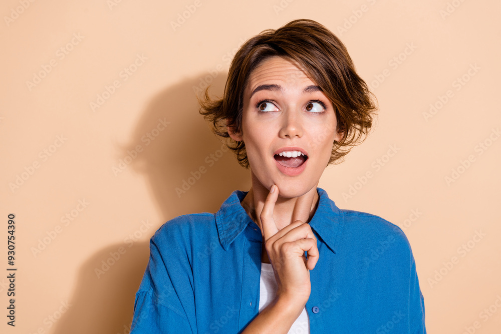 Sticker Photo portrait of attractive young woman look shocked empty space wear trendy blue clothes isolated on beige color background