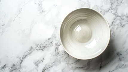 Top view of white ceramic dish on marble table texture