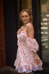 Naklejka premium A Trendy Summer Dress Fashion Model Posing Beautifully in a Lively Urban Setting