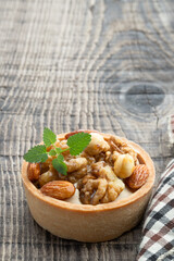 Tart with nuts and caramel on a rustic wooden background