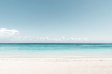 Obraz premium Serene tropical beach with turquoise water, white sand, and a pale blue sky dotted with wispy clouds on the horizon