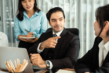 Diverse of business people from various ethnic group working in modern office environment. Productive and multi ethnic office workers engage in discussion for strategic business marketing. Habiliment