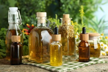 Different tinctures in bottles and medicinal herbs on wooden table
