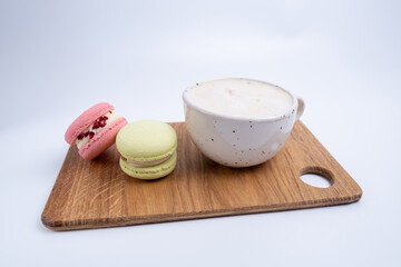 Macarons on a colored background, French cookies. Gift for March 8, International Women's Day, Valentine's Day. Sweets for coffee and tea