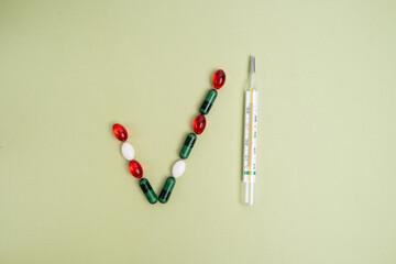 Medical thermometer close-up and tablets. Traditional thermometer for measuring body temperature, Medicine and health concept