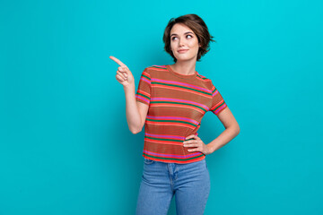 Photo of cute woman with bob hairstyle dressed striped t-shirt indicating look at empty space offer isolated on turquoise color background