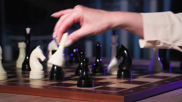 confrontation of sexes, young woman and man playing chess on a chessboard, business and strategy
