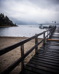 Paisajes de la Patagonia Argentina durante otoño, donde se pueden apreciar puertos y cabañas entre las imponentes montañas y los increíbles lagos junto con una tupida y colorida vegetación.
