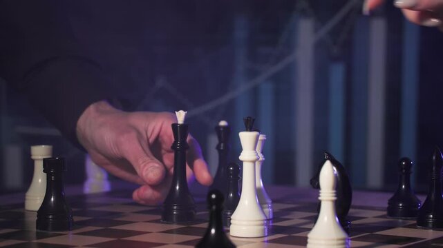 concept of economic planning in business, men making a move with a shaman figure on a chessboard, close-up