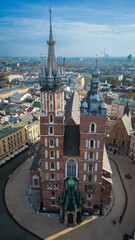 a large building with a clock on the front in the old town of krakow poland