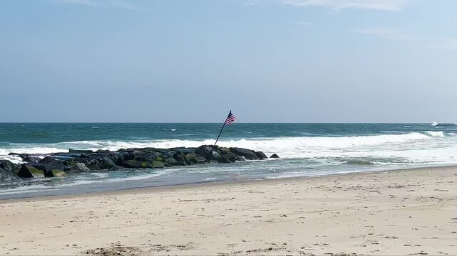 Allenhurst, New Jersey - August 18, 2024: Waves crash against the jetty in Allenhurst as Hurricane Ernesto churns in the Atlantic Ocean