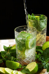 Detox drink with mint lime and mineral water in a glass jar