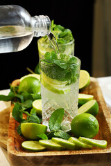 Detox drink with mint lime and mineral water in a glass jar