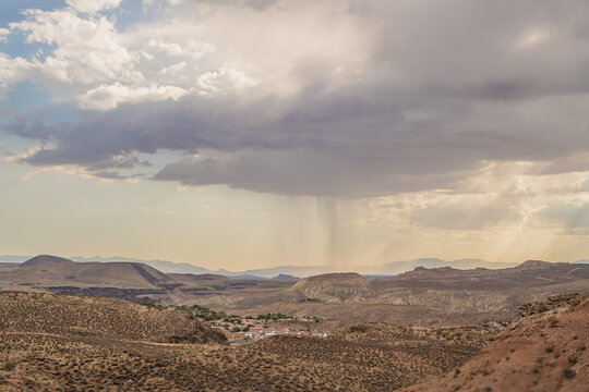 Rain in Distance Water Falling Clouds Over Desert Landscape