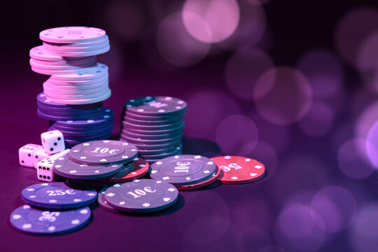 Poker chips and dices on dark background