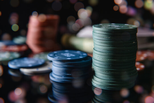 Chips for poker on dark background, closeup