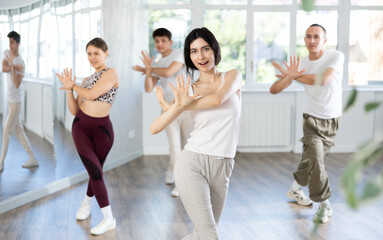 Group of young guys and girls dancing jazz funk in the studio
