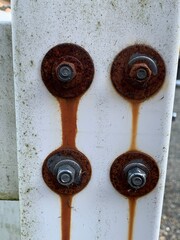 Rusting bolts on a fence