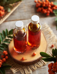 Rowan berry syrup in two glass bottles