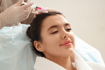 Naklejka premium Young woman receiving hair injection in beauty salon, closeup