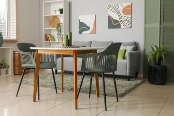 Stylish light living room with soft sofa, table and shelving unit