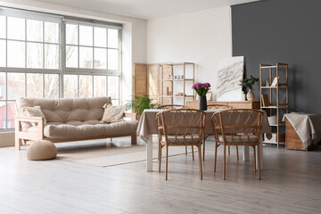 Interior of room with dining table and sofa