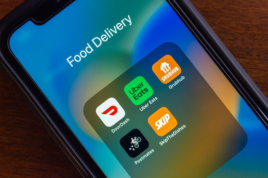 Vancouver, CANADA - Jul 15 2024 : Icons of DoorDash, Uber Eats, Grubhub, Postmates and SkipTheDishes seen in an iPhone screen. Food Delivery Services in Canada and North America Concept
