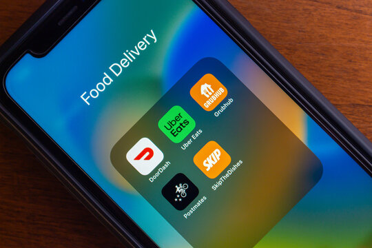 Vancouver, CANADA - Jul 15 2024 : Icons of DoorDash, Uber Eats, Grubhub, Postmates and SkipTheDishes seen in an iPhone screen. Food Delivery Services in Canada and North America Concept