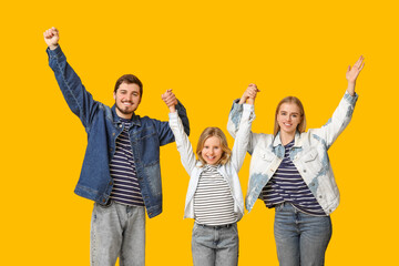 Obraz premium Happy family in stylish denim clothes on yellow background