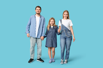 Happy family in stylish denim clothes on blue background