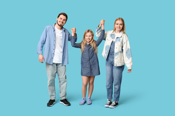 Fototapeta premium Happy family in stylish denim clothes on blue background