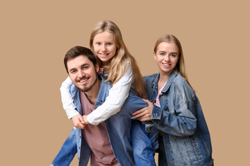 Obraz premium Happy family in stylish denim clothes on brown background